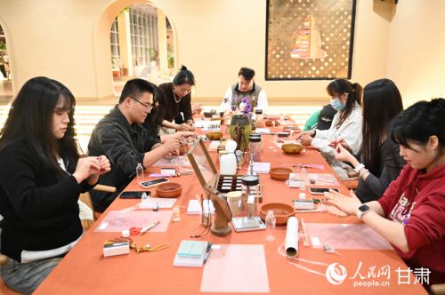市民游客在敦煌无界制作手工艺品。人民网 席娟娟摄