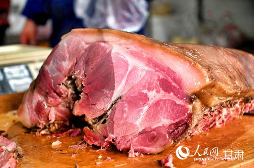 色泽红润、油脂晶莹的陇西腊肉是当地代表性的传统美味。人民网记者 焦隆摄